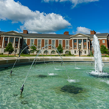 A campus building viewed through a fountain. Link to Tangible Personal Property